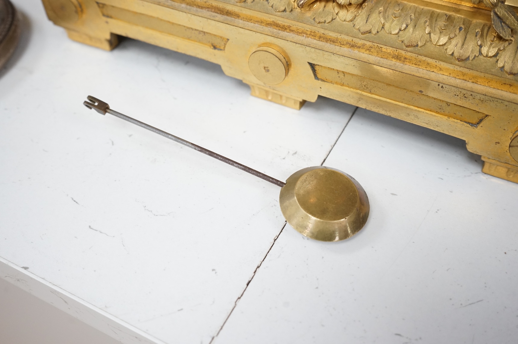 A 19th century French gilt bronze mantel clock, with classical figural surmount and floral painted dial, clock 54cm high.